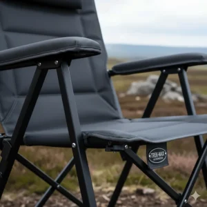 Close-up of a heavy-duty portable camping chair with reinforced steel frame and padded armrests.