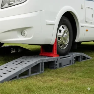 A heavy coachbuilt motorhome wheel secured on a levelling ramp with a matching wheel chock for safety.