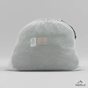 A down camping sleeping bag stored loosely in a large mesh storage sack to maintain the natural loft of the down.