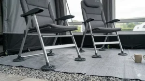 Detailed view of wide, anti-sink feet on a folding chair designed to protect a caravan awning groundsheet.