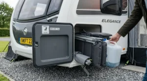Two slim-profile folding chairs stored neatly inside an external caravan locker alongside a water carrier.
