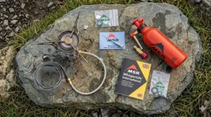 A top-down view of the MSR WhisperLite International kit, including the stove, fuel pump, windscreen, and maintenance tool.