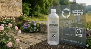 A one hundred percent recyclable British-made bottle of eco toilet fluid featuring the official UK recycling logo against a countryside backdrop.