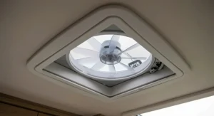 Internal view looking up at a standard 400mm x 400mm caravan roof vent fan installation, showing the neat bezel and integrated flyscreen.