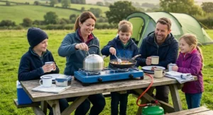 Two large cooking pans sitting side-by-side on a wide-base camping stove, demonstrating capacity for a family of four.