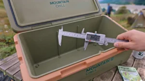 A packed cool box divider keeping groceries cold during a weekend camping trip in the UK countryside.
