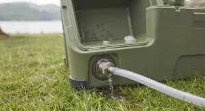 Close-up of the drainage valve on a robust personal cool box for easy cleaning.
