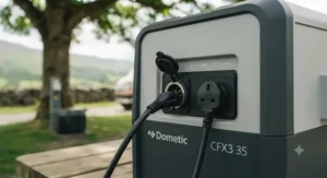 A detailed view of the connection panel on a Dometic electric cool box, clearly showing both the 12V DC socket and the 230V AC mains input for versatile power options.