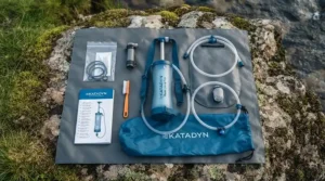 Complete kit contents of a pump water filter for group expeditions laid out on a waterproof groundsheet.
