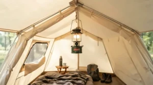 A small butane camping lantern hanging securely inside a family tent during a rainy weekend getaway.